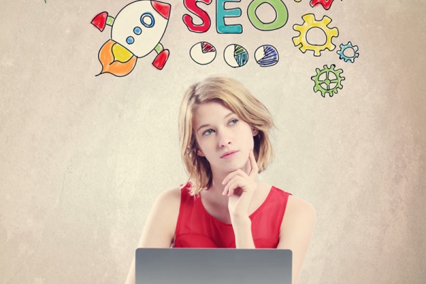 SEO concept with woman working on a laptop